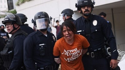 LAPD officers arrest a protestor wearing a "Arrest Trump, Not Migrants" shirt following clashes near the Metropolitan Detention Center during the "No Kings" national day of protest in Los Angeles on March 28, 2026. (Photo by Etienne Laurent / AFP) (AFP) LAPD officers arrest a protestor wearing a "Arrest Trump, Not Migrants" shirt following clashes near the Metropolitan Detention Center during the "No Kings" national day of protest in Los Angeles on March 28, 2026. (Photo by Etienne Laurent / AFP) (AFP)