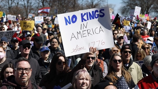 People hold signs as they rally at Grant Park during the "No Kings" national day of protest in Chicago on March 28, 2026. (Photo by KAMIL KRZACZYNSKI / AFP)(AFP)