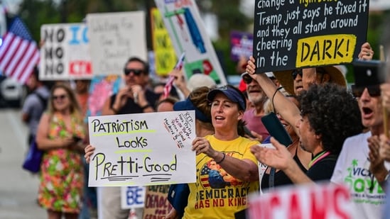 Protesters hold signs and flags near US President Donald Trump's Mar-a-Lago resort during the "No Kings" national day of protest, in Palm Beach, Florida, on May 28, 2026. (Photo by Giorgio VIERA / AFP)(AFP)