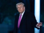 US President Donald Trump waves to the media as he walks on the South Lawn upon his arrival at the White House.