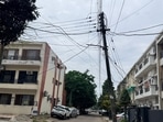 Low-hanging electricity and telecom broadband cables clutter residential streets in Sector 15, Chandigarh. (Ravi Kumar/HT)