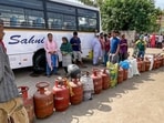 People queue up to avail LPG cylinders amid ongoing supply crunch, in Dilshad Colony, Delhi, Saturday, March 28