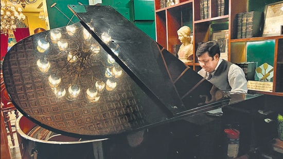 The reflection of the chandelier is spreading across the piano’s slanted lid. (Mayank Austen Soofi)