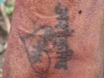 Tattoo helps police identify a decapitated man, business partners held