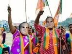 JP supporters wear masks of Assam CM Himanta Biswa Sarma during their party candidate's nomination rally, in Guwahati 