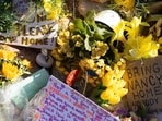 An ever-growing collection of yellow flowers and notes sit at the home of Nancy Guthrie, the missing mother of "Today" show host Savannah Guthrie, in Tucson, Ariz., Friday, March 6, 2026. (AP Photo/Rebecca Noble)