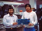 Apple co-founders Steve Jobs and Steve Wozniak with an early circuit board