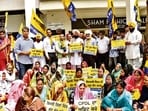 AAP workers protesting outside the CPDL office in Sector 34, Chandigarh, on Wednesday. (HT Photo)