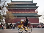 A woman looks at her phone while riding at the Drum Tower in Beijing, China, Tuesday, March 31, 2026. (AP Photo/Vincent Thian) A woman looks at her phone while riding at the Drum Tower in Beijing, China, Tuesday, March 31, 2026. (AP Photo/Vincent Thian)