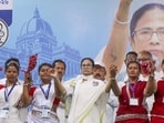 West Bengal chief minister Mamata Banerjee with tribal artists during a public rally in support of TMC candidate from Hasan constituency, Kajal Sheikh, ahead of the assembly elections on Wednesday (PTI)