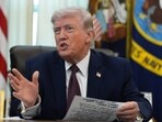 President Donald Trump answers questions from reporters after signing an executive order in the Oval Office of the White House Tuesday, March 31