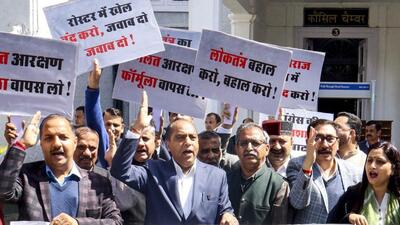 Himachal Pradesh leader of opposition Jai Ram Thakur along with BJP MLAs staging a protest against the Sukhvinder Singh Sukhu-led Congress government during the budget session of the assembly in Shimla on Wednesday. (PTI Photo) Himachal Pradesh leader of opposition Jai Ram Thakur along with BJP MLAs staging a protest against the Sukhvinder Singh Sukhu-led Congress government during the budget session of the assembly in Shimla on Wednesday. (PTI Photo)