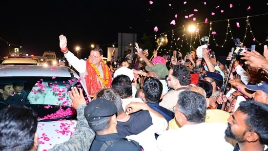 Chief Minister Pushkar Singh Dhami being welcomed by supporters during his road show in Udham Singh Nagar district.