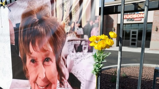 A flower is placed next to a photo of Nancy Guthrie as authorities continue to search for Savannah Guthrie's mother. (Getty Images via AFP)