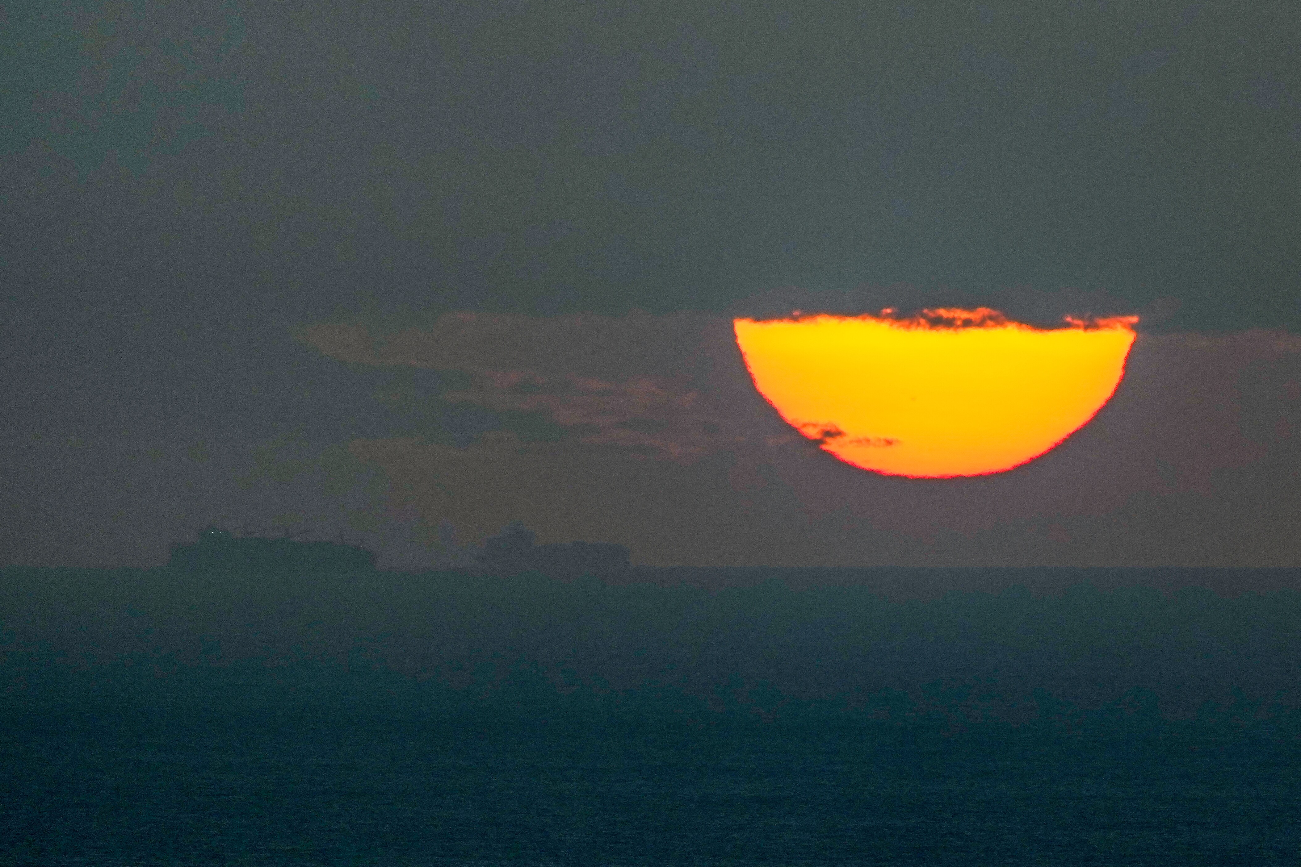 Ships sail through the Arabian Gulf toward the Strait of Hormuz as the sun sets in the United Arab Emirates Monday, March 23, 2026. (AP)