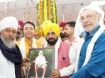 CM Bhagwant Mann along with health minister Dr Balbir Singh in Sangrur on Thursday. (HT)