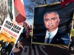 Demonstrators carry a photograph of Reza Pahlavi as people who support the US and Israel strikes on Iran, rally near the White House in Washington.