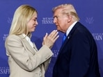 Former Attorney General Pam Bondi applauds as President Donald Trump walks past her at a roundtable on public safety 