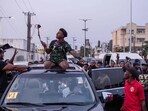 US YouTuber and online streamer Darren Jason Watkins Jr, better known as IShowSpeed (C) broadcasts to his followers during an event at the Admiralty Mall in Lagos.