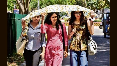 Students take cover under a scarf in Panchkula on a sunny Thursday. The mercury climbed from 32.8°C to 35.7°C in the past 24 hours, 3.1 degrees above normal and highest so far this season. (Sant Arora/HT)