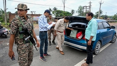 Malda: Security personnel conduct naka checking of vehicles along National Highway 12 (NH 12) as part of election security measures, in Malda (PTI) Malda: Security personnel conduct naka checking of vehicles along National Highway 12 (NH 12) as part of election security measures, in Malda (PTI)