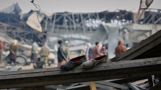 Residents and rescue workers inspect the site of an airstrike at a drug rehabilitation hospital in Kabul, Afghanistan on March 17 (AP)
