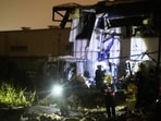 Israeli security forces and rescue teams inspect a site struck by an Iranian missile in Petah Tikva, Israel,Thursday, April 2, 2026.