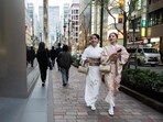 Friends walk through a shopping area in Tokyo’s Ginza district (Andrew Caballero-Reynolds/AFP)