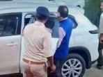 MP Assembly Secretariat principal secretary Arvind Sharma leaving the complex (X/Screenshot)
