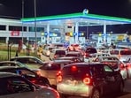 Vehicles wait for their turn to get fuel at a petrol station, as Pakistan raises fuel prices. 