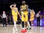 Los Angeles Lakers forward LeBron James, right, and guard Austin Reaves stand during a timeout Los Angeles Lakers forward LeBron James, right, and guard Austin Reaves stand during a timeout