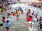 Devotees take a holy dip in River Godavari during the Simhastha Kumbh Mela at Ramkund in Nashik. (PTI Photo)