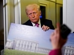 A member of the media raises her hand for a question as President Donald Trump talks