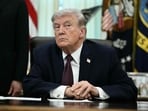 Donald Trump takes a question from a reporter after signing an executive order in the Oval Office