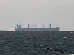 FILE PHOTO: A cargo ship in the Gulf, near the Strait of Hormuz, as seen from northern Ras al-Khaimah, near the border with Oman’s Musandam governance.