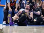 Los Angeles Lakers guard Luka Doncic (77) falls to the court during a play against the Oklahoma City Thunder 