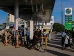 People get fuel at a petrol station, as fuel prices in Pakistan rise, amid the US-Israeli conflict with Iran, in Karachi.