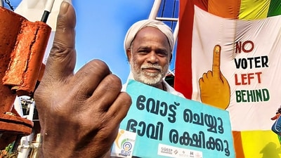 A voter holds a placard during the Systematic Voters' Education and Electoral Participation, a voter awareness initiative, ahead of the Kerala assembly elections, in Kozhikode. (PTI) A voter holds a placard during the Systematic Voters' Education and Electoral Participation, a voter awareness initiative, ahead of the Kerala assembly elections, in Kozhikode. (PTI)