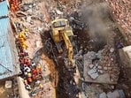 An aerial view of the site where a four-story building collapsed on 4th April at Kotma, in Anuppur on Sunday. Search and rescue operations by NDRF are underway.
