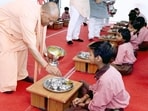 Chief minister Yogi Adityanath serving mid-deal to students in Varanasi. (SOURCED IMAGE) Chief minister Yogi Adityanath serving mid-deal to students in Varanasi. (SOURCED IMAGE)