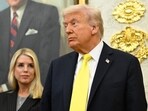 President Donald Trump and former Attorney General Pam Bondi listen as FBI Director Kash Patel speaks during an event