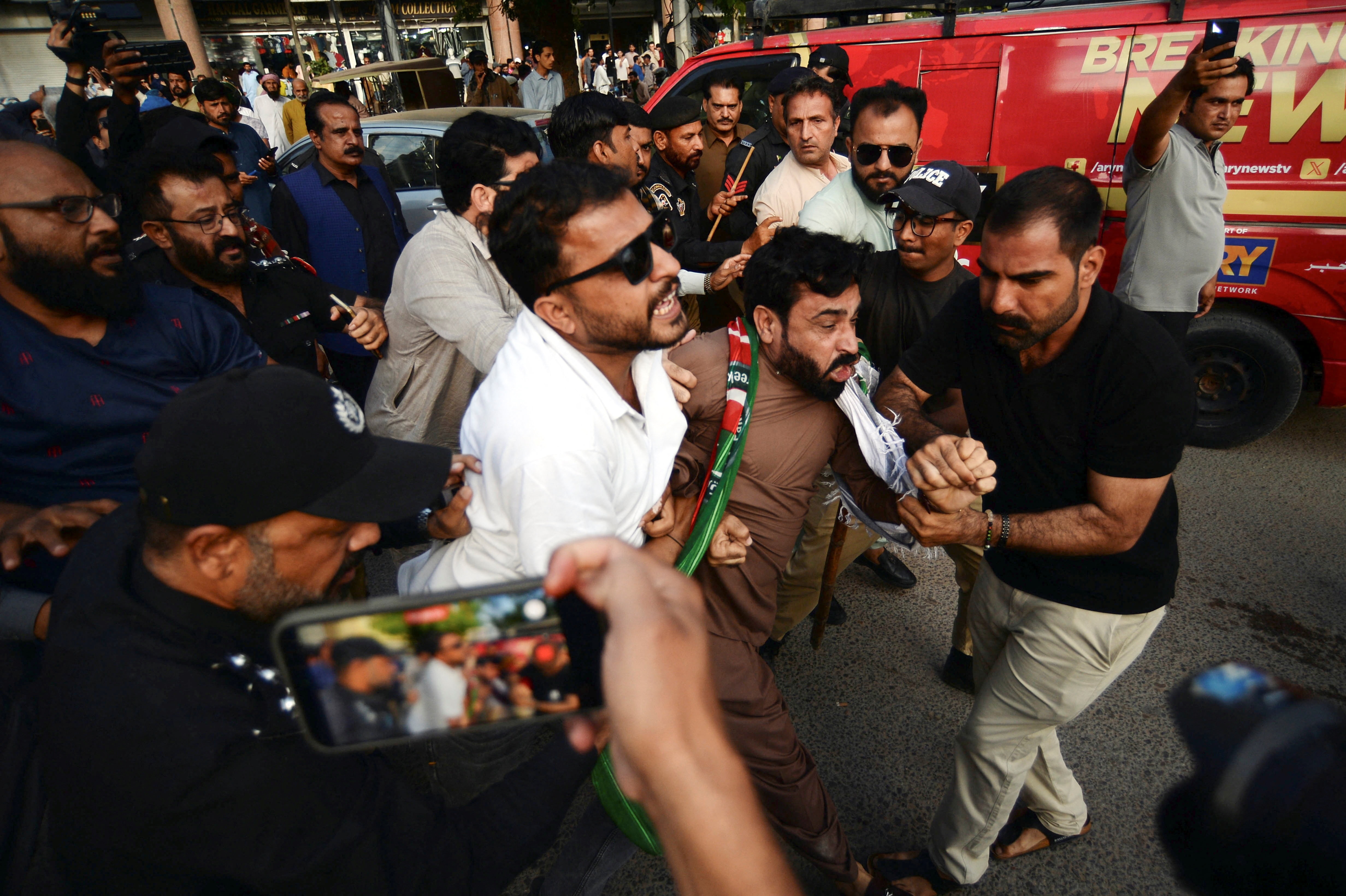 Police clash with supporters of the Pakistan Tehreek-e-Insaf (PTI) party during a protest against rising inflation and petroleum prices in Karachi, Pakistan, (REUTERS)