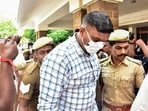 Police escort a convict outside a court premises in connection with the Sathankulam custodial death case, in Madurai, Monday, April 6, 2026. 