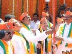 UP BJP chief Pankaj Chaudhary, deputy CM Brajesh Pathak and others hoisting party flag at Lucknow office on April 6. (HT photo)