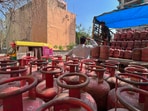 Workers unloading LPG cylinders in Sector 12 on Thursday. (Parveen Kumar/HT)