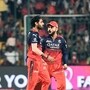 Royal Challengers Bengaluru's Virat Kohli and Bhuvneshwar Kumar celebrate the wicket of Gujarat Titans' captain Shubman Gill