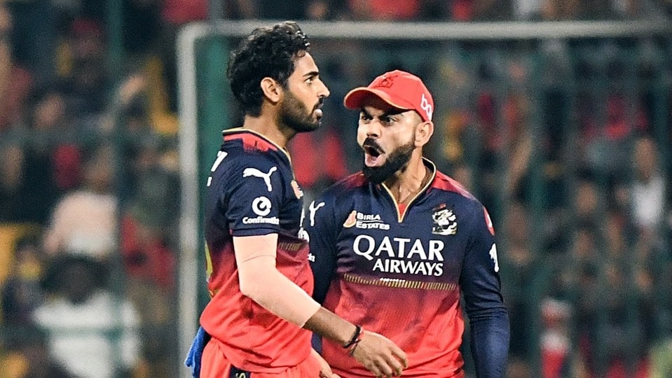 Royal Challengers Bengaluru's Virat Kohli and Bhuvneshwar Kumar celebrate the wicket of Gujarat Titans' captain Shubman Gill