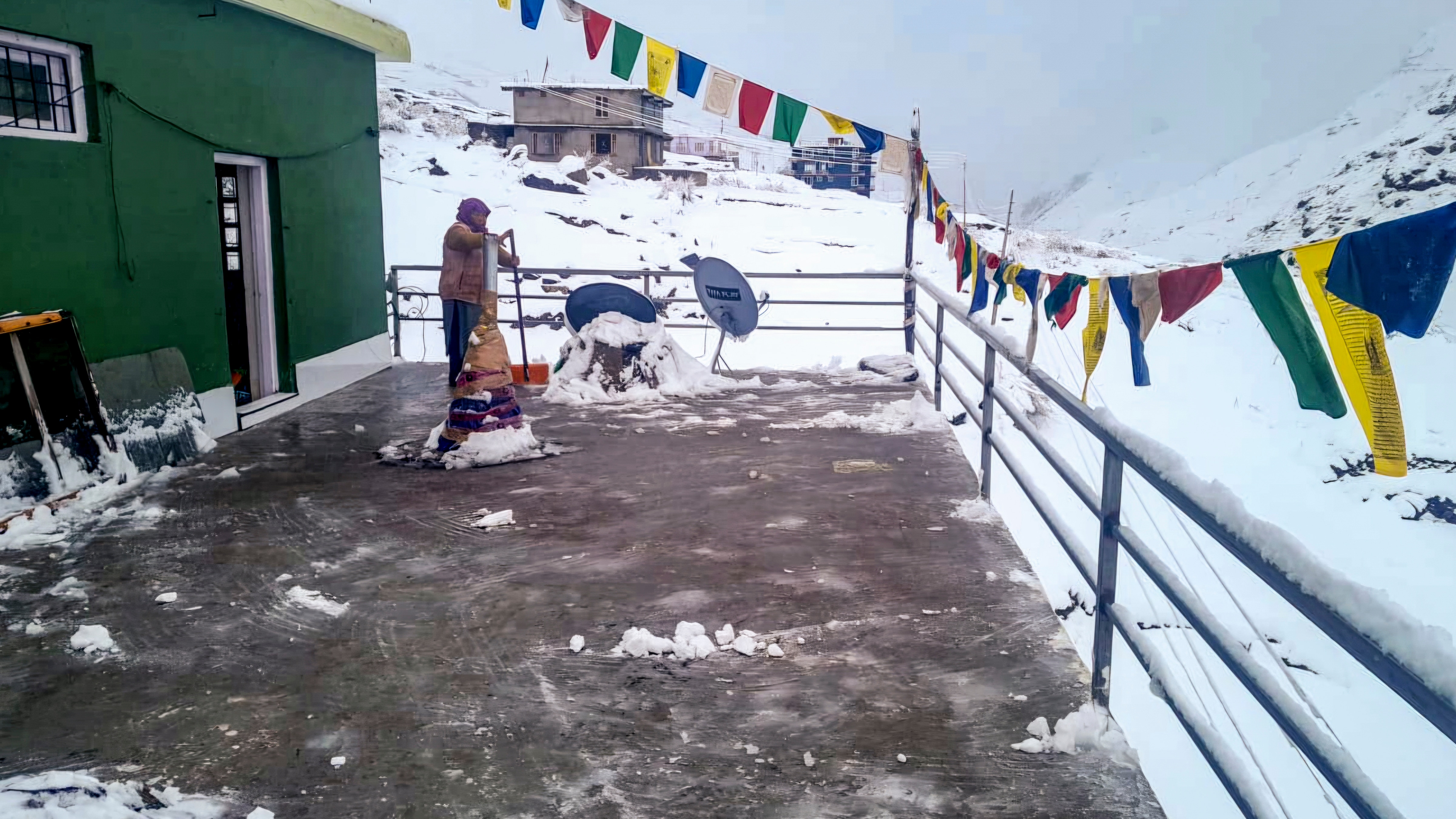 A resident clears snow following fresh snowfall, in Sissu, Lahaul and Spiti district, Himachal Pradesh, Saturday, April 4, 2026. (PTI) A resident clears snow following fresh snowfall, in Sissu, Lahaul and Spiti district, Himachal Pradesh, Saturday, April 4, 2026. (PTI)