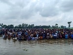 Bangladeshi nationals assemble close to the Sitalkuchi fenced land border in Cooch Behar in their bid to crossover to India. (PTI File)