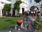 Police personnel inspect a flower bouquet after an SUV driven by a masked man forced its way through one of the boundary gates of the Delhi Assembly premises,  The driver escaped from the same route after placing a flower bouquet outside the Speaker's office in New Delhi, India, on Monday, April 6, 2026. 